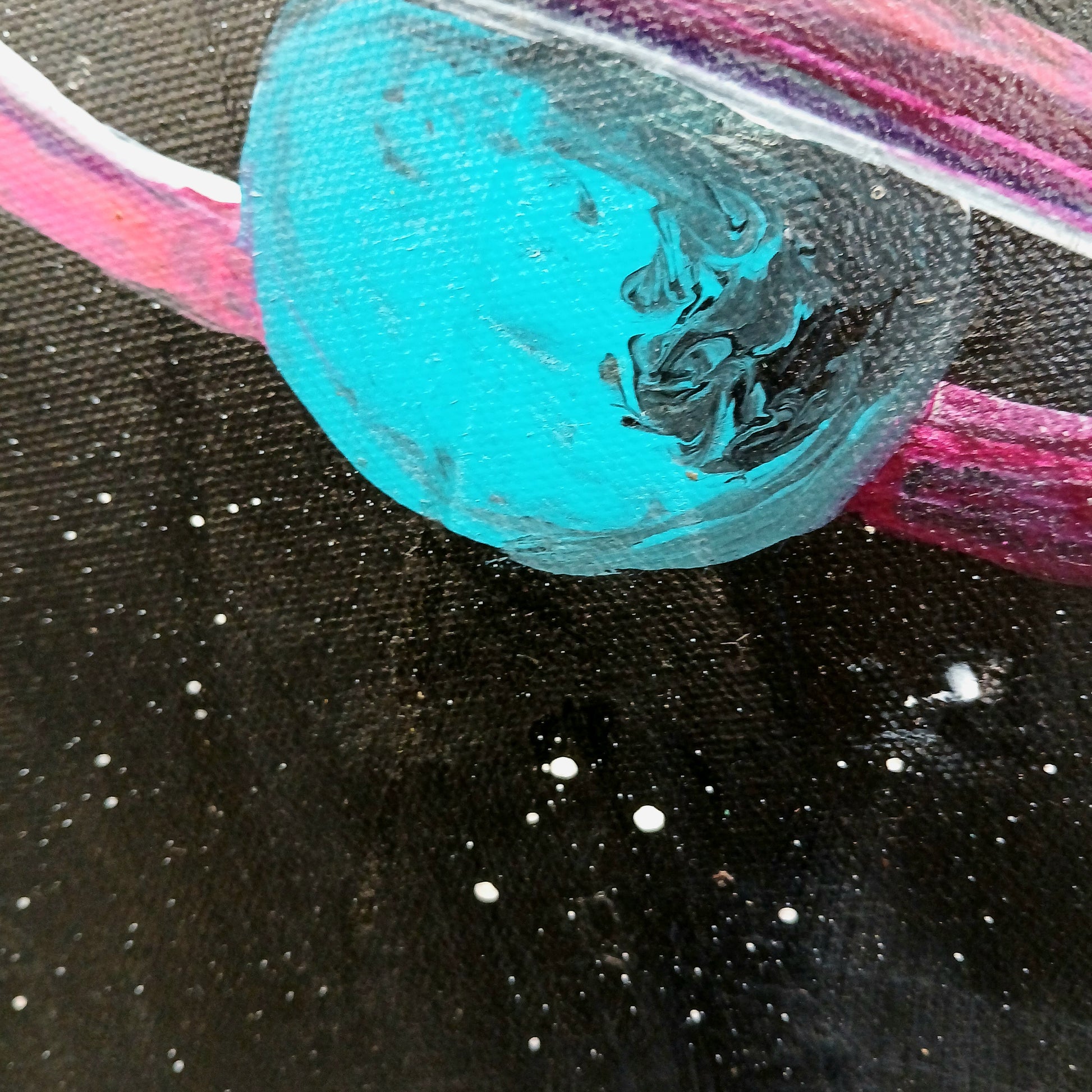 Turquoise and black marbled moon  with colorful rings like Saturn. In the dark Galaxy